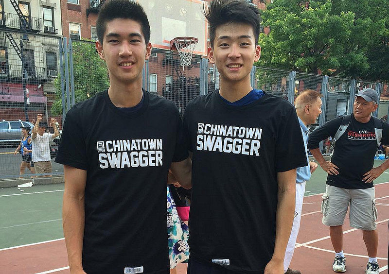 Two young Chinese American men wearing black and white Chinatown Swagger T-shirts