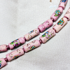 Close up of tube-shaped cloisonne design necklace - pink