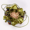 Green pouch partially open with pearls inside